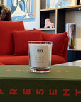 HoV Paris Scented Candle - Desert Du Khorasan (190 g) - product shown on book in living room