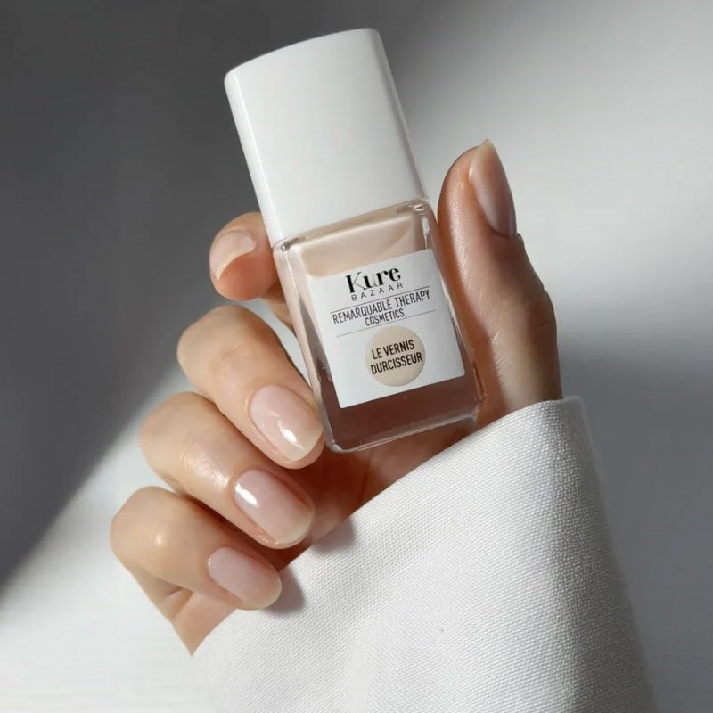 Kure Bazaar Colored Nail Hardener - Beige - model shown holding product