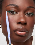 Kosas Soulgazer Eyeliner - Eternal - model shown wearing and holding product