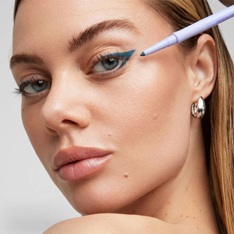 Kosas Soulgazer Eyeliner - Cosmic - model shown wearing and holding product