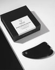 Snow Fox Skincare Black Obsidian Hot Stone Gua Sha - product shown next to packaging on table