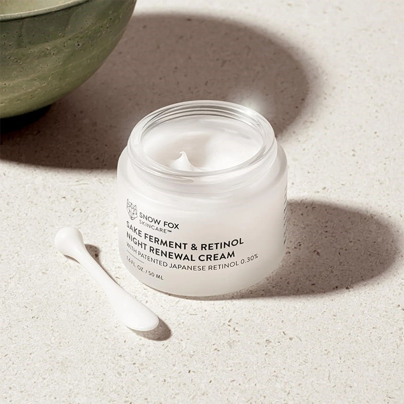 Snow Fox Skincare Sake Ferment & Retinol Night Renewal Cream - product shown with lid off next to included applicator