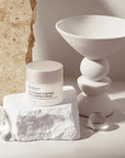 Snow Fox Skincare Sake Ferment & Retinol Night Renewal Cream - product shown next to stones and glass