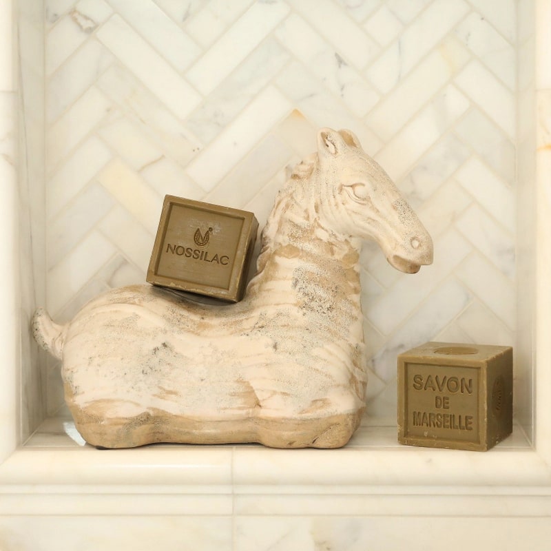 Nossilac Authentic Marseille Soap Cube - two products shown on horse sculpture