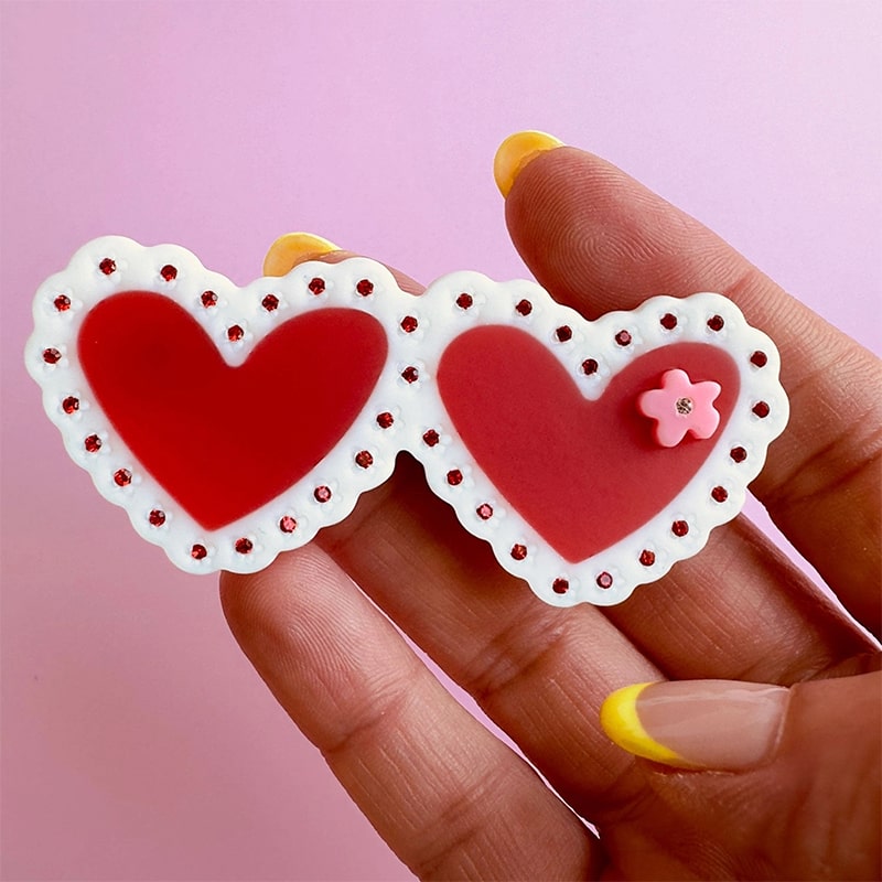 Centinelle Valentines Laced Hearts Hair Clip - model shown holding product