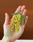 Botanopia Embroidered Brooch - Mimosa Flowers - model shown holding product