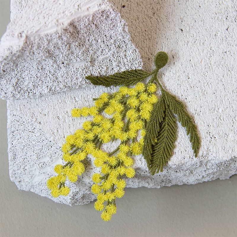 Botanopia Embroidered Brooch - Mimosa Flowers - product shown on top of rock