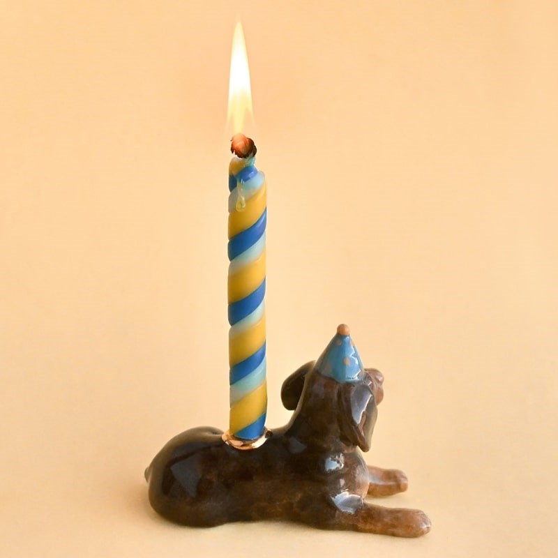 Camp Hollow Dachshund Cake Topper - backside of product shown with lit candle in it