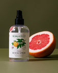 Koala Eco Natural Room Spray - Pink Grapefruit and Peppermint Essential Oil - product shown next to sliced grapefruit 