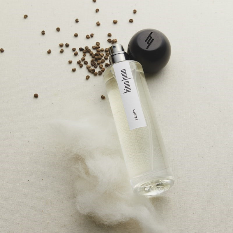 Hima Jomo Pashm Eau de Parfum - product shown next to fragrance ingredients