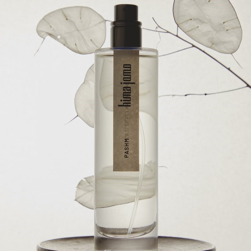 Hima Jomo Pashm Eau de Parfum - product shown in from of leaf and branch